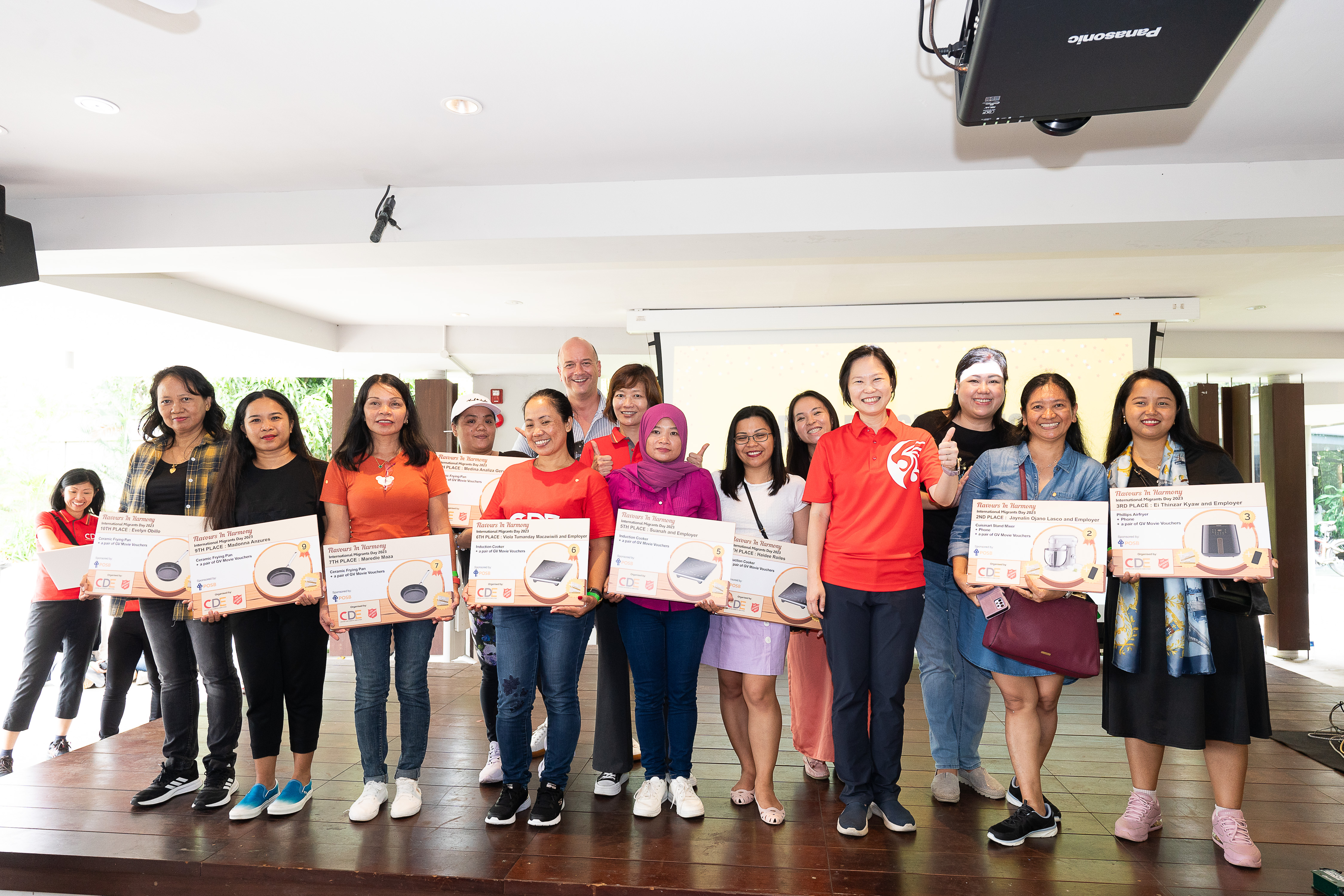 Minister of State for Manpower, Ms Gan Siow Huang, on stage with winners of the cookbook competition